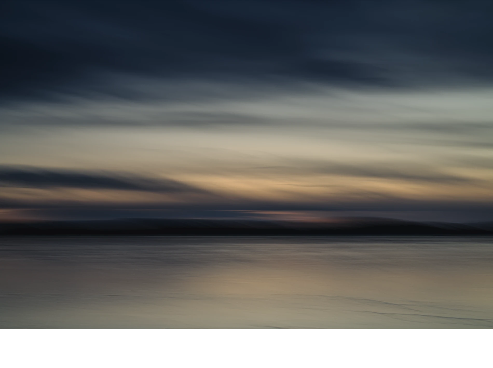 Abstract-seascape-color-photograph-copyright-photographer-Kenneth-Rimm-2 Contemporary abstract seascape photograph in warm muted colors and muted dark ocean blue / steel blue colors from the cloudy twilight sky reflecting in the ice covered water, from the Liquid Light seascapes series by fine art photographer Kenneth Rimm.