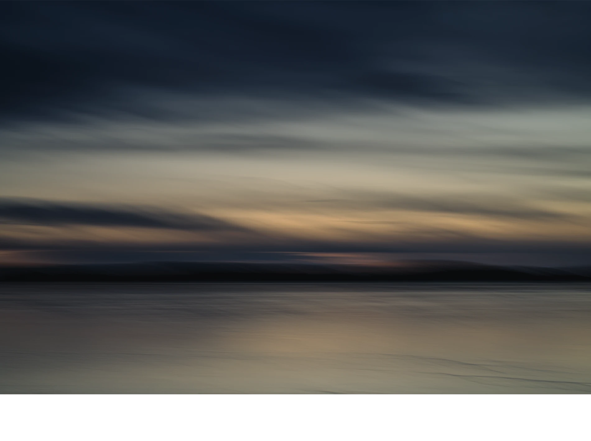 Abstract-seascape-color-photograph-copyright-photographer-Kenneth-Rimm Contemporary abstract seascape photograph in warm muted colors and muted dark ocean blue / steel blue colors from the cloudy twilight sky reflecting in the ice covered water, from the Liquid Light seascapes series by fine art photographer Kenneth Rimm.
